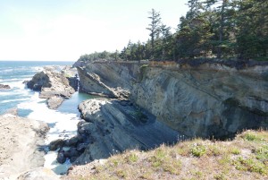 Exposed cliff showing tilted layers of rock and soil.